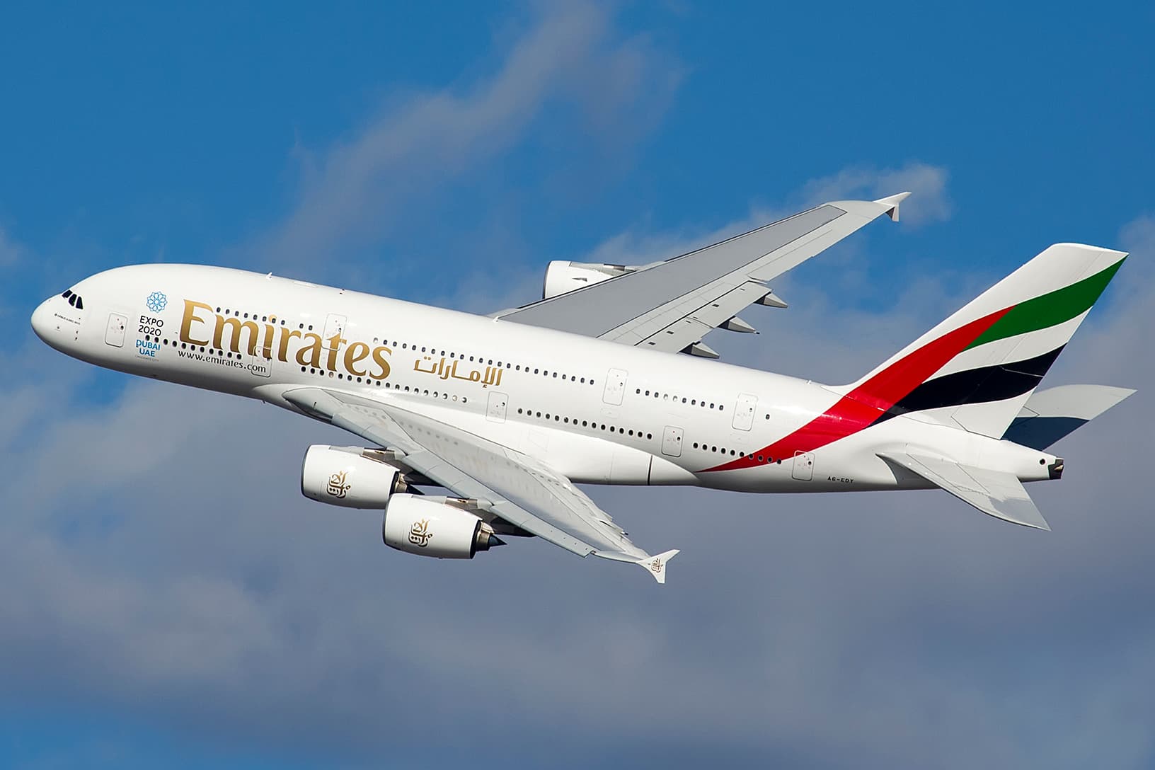 Emirates airliner climbing through open sky